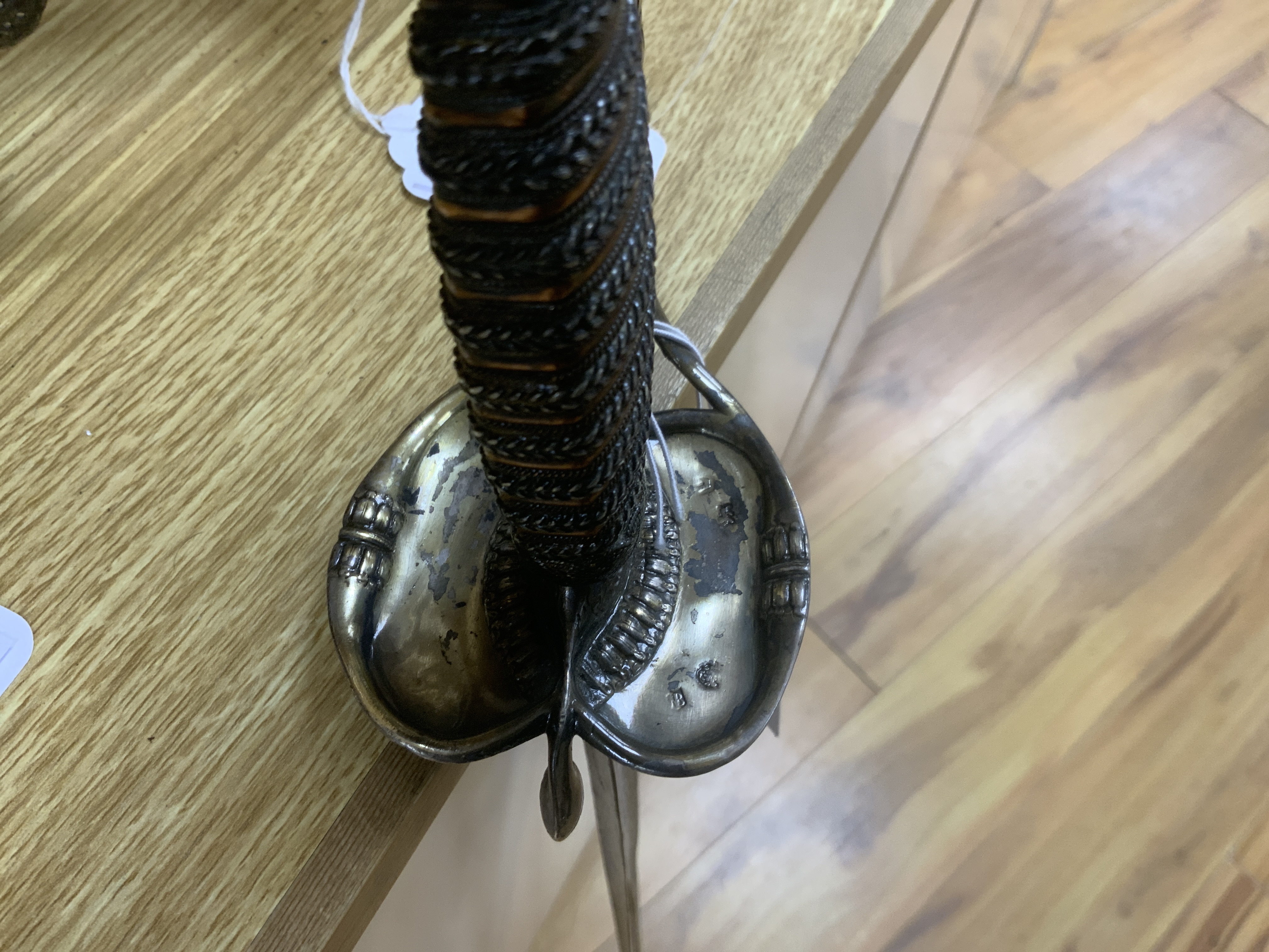 An English hallmarked silver hilted small sword, late 17th century, the Charles II hilt by William Badcock, London 1680, of conventional form, later grip bound with copper tape and twisted silver wire, colichemarde shape